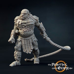May include: A grey, detailed miniature of a large, muscular, humanoid figure wearing chainmail armour, a chain around its neck, and holding a rope whip in its right hand. The figure has a large, flat nose, a wide mouth, and a fierce expression.