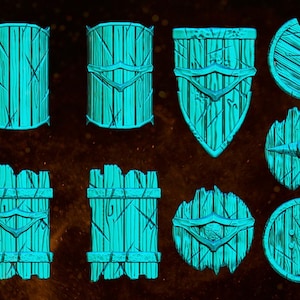 May include: A set of nine glowing green Orc shields, with various designs and shapes, including round, oval, and rectangular. The shields are made of wood and have a rough, textured surface. The text "OCTOBER PACK ORC SHIELDS" is visible in the top left corner of the image.