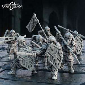 May include: A collection of miniature fantasy figures, possibly for tabletop gaming. The figures are wearing armour, helmets, and shields, and are holding spears and a flag. The figures are in a battle formation. The text "THE PRINTING GOES EVER ON" is visible in the upper left corner.