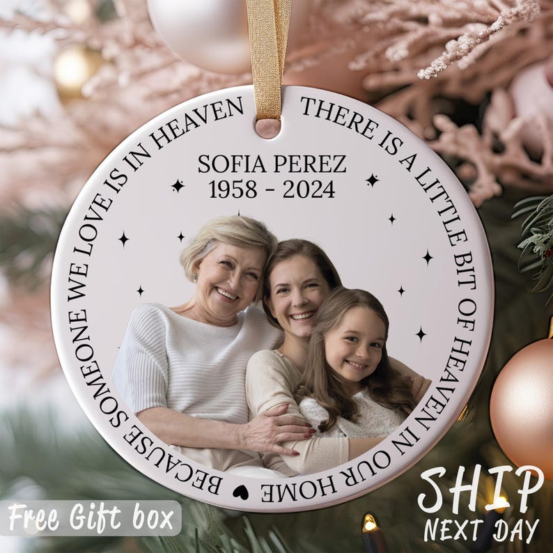 May include: White ceramic ornament with a photo of three women and the text "Because someone we love is in heaven. There is a little bit of heaven in our home."  The text also includes "Sofia Perez 1958-2024".
