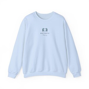 May include: Light blue sweatshirt with a logo that says "KAYTASTIC -learning- " and a stylized image of an open book.