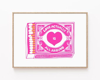May include: A pink and yellow illustration of a matchbox with the text "Love Actually Is All Around" and a pink heart in the center.