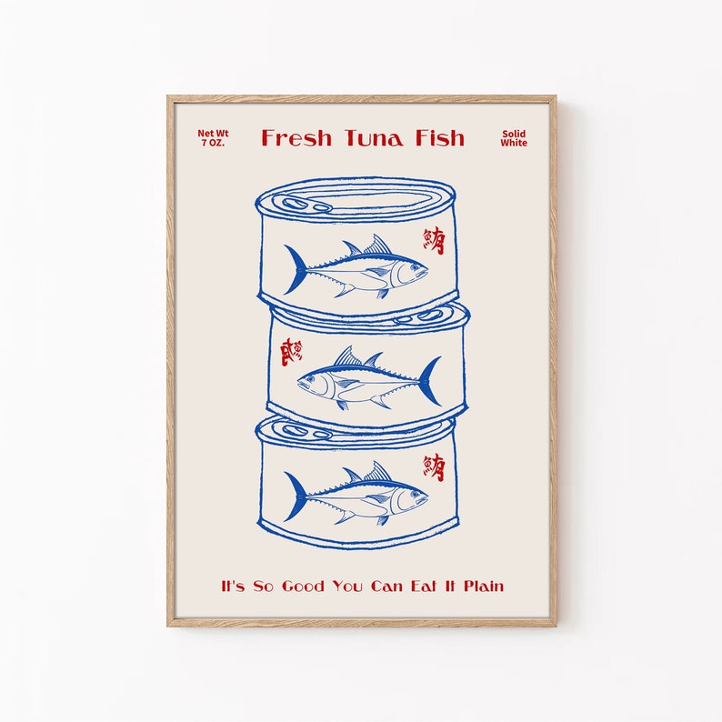 May include: A framed print featuring three stacked tuna fish cans. Each can is illustrated with a blue tuna fish and red Japanese characters. The text "Fresh Tuna Fish" and "It's So Good You Can Eat It Plain" are also displayed.