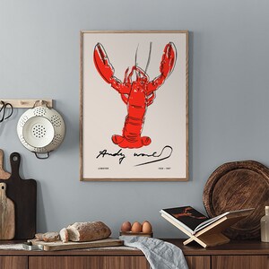 May include: A framed print of a red lobster with black outlines, signed "Andy Warhol" with the text "Lobster 1928-1987" below the image.
