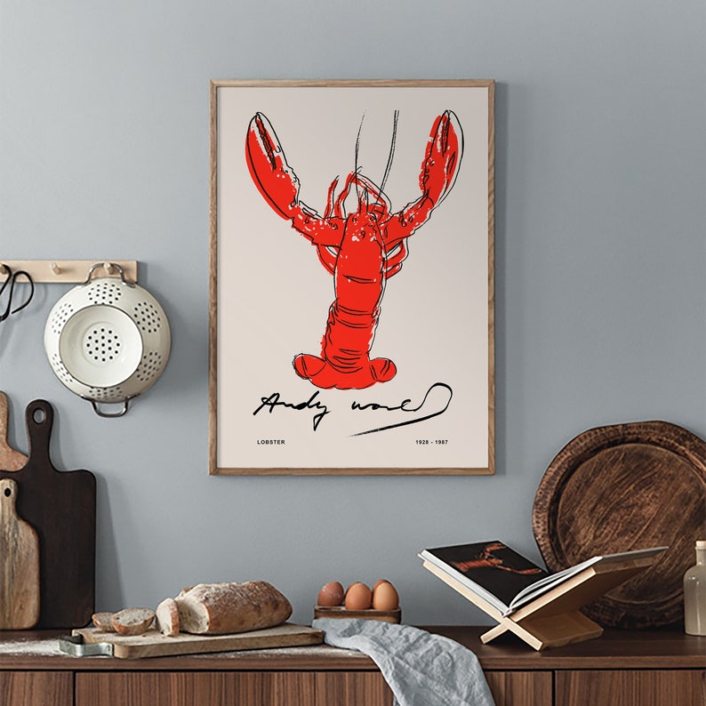 May include: A framed print of a red lobster with black outlines, signed "Andy Warhol" with the text "Lobster 1928-1987" below the image.
