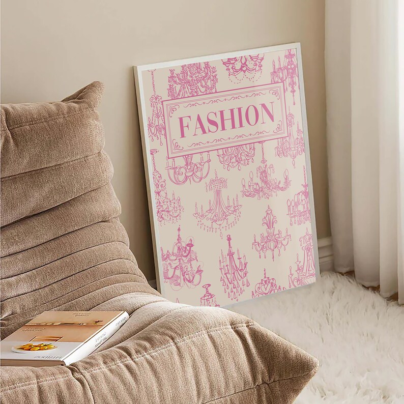 May include: A white poster with a pink design of chandeliers and the word "FASHION" in pink lettering.