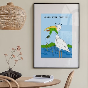 May include: A framed illustration of a white bird with a long beak holding a green frog in its beak. The bird is standing in blue water with green reeds. The text "NEVER EVER GIVE UP!" is printed above the bird.