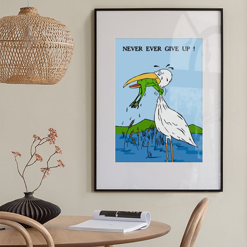 May include: A framed illustration of a white bird with a long beak holding a green frog in its beak. The bird is standing in blue water with green reeds. The text "NEVER EVER GIVE UP!" is printed above the bird.