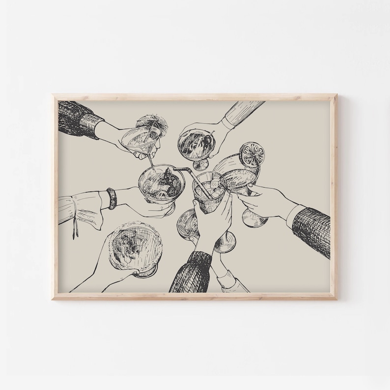May include: A black and white line drawing of friends raising their glasses in a toast. The drawing is on a beige background and framed in a light wood frame.