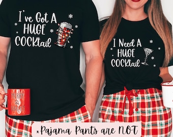 May include: A couple's matching Christmas pajama shirts. The man's shirt says "I've Got A HUGE COCKtail" with a glass of beer with lights around it. The woman's shirt says "I Need A HUGE COCKtail" with a martini glass. The text "*Pajama Pants are NOT included*" is at the bottom of the image.