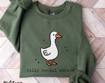 May include: A green sweatshirt with a white goose illustration and the text "silly social worker".