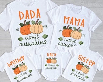 May include: White t-shirts with orange text and pumpkin graphics. The shirts read "DADA", "MAMA", "Brother", "Sister", and "BABY" with the phrase "of the cutest pumpkins". A baby onesie is also included.
