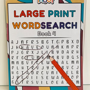 May include: A Large Print Wordsearch puzzle book, Book 4, with the word "HAVE" circled in the puzzle. A pencil and a black pen are on the table. The book cover has the word "ihoot" at the top.