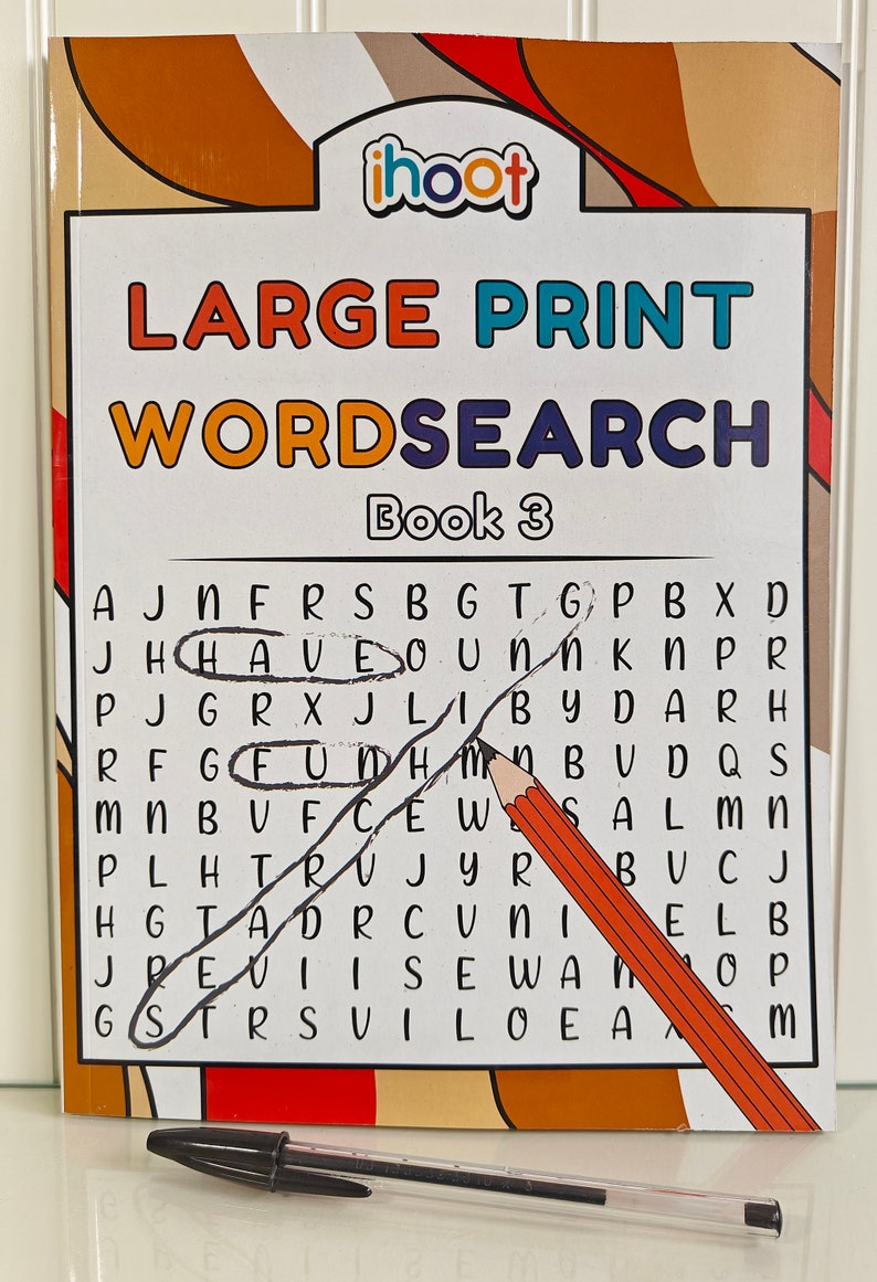 May include: A "Large Print Wordsearch Book 3" with the word "HAVE" circled and the word "FUN" circled. A pencil and a black pen are on the page. The book has a white background with a brown and orange border.