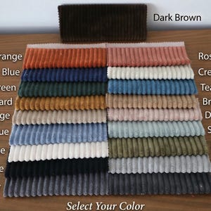 May include: A color chart of corduroy fabric swatches in various colors, including Burnt Orange, Medium Blue, and Rose Pink. The text "Select Your Color" is at the bottom, and "Dark Brown" is at the top. The fabric is arranged in neat rows.