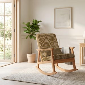 May include: A wooden rocking chair with a patterned seat and backrest. The chair has a light brown frame and is placed on a textured rug. A small side table with a lamp and a potted plant are also visible.