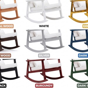 May include: A selection of rocking chairs in different colours: natural wood, white, gold, dark wood, silver, dark blue, black, burgundy, and dark green. Each chair has a white cushion and pillow.