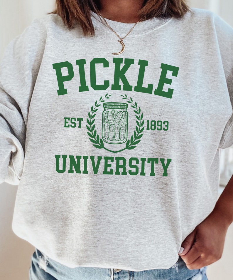 May include: Grey sweatshirt with green text that reads "Pickle University" with a green wreath and a jar of pickles inside. The text "Est 1893" is below the wreath.