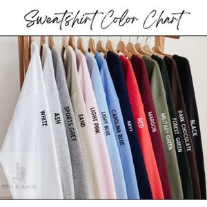 May include: Colour chart displaying 12 different sweatshirt colours, including black, dark chocolate, forest green, military green, maroon, red, navy, Carolina blue, light blue, light pink, sand, sports grey, ash, and white.