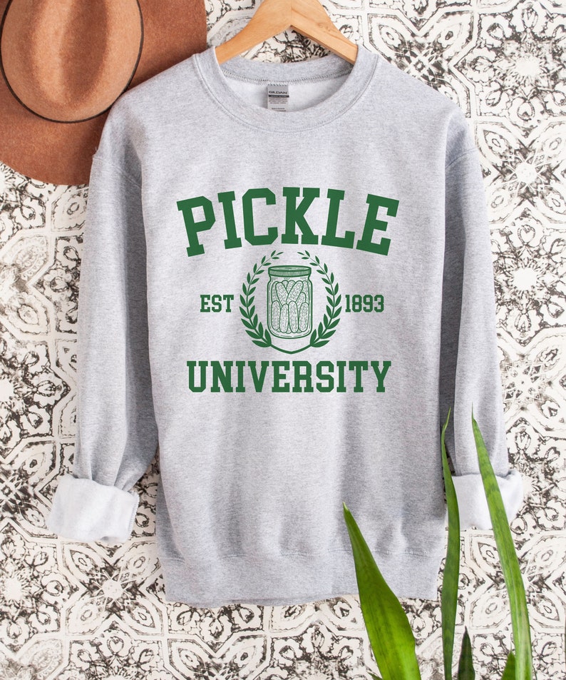 May include: A grey sweatshirt with a green print that says "Pickle University" with an illustration of a jar of pickles and the text "Est. 1893".