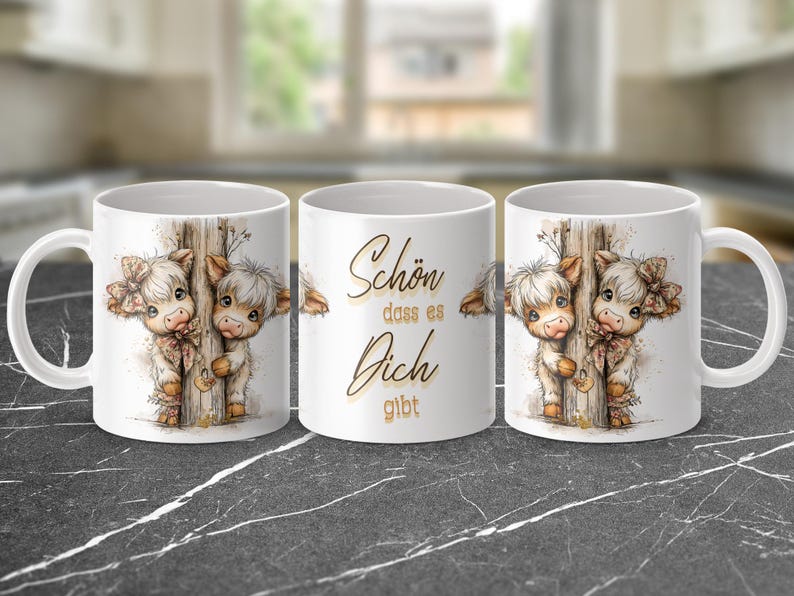 May include: White ceramic mug featuring a watercolor illustration of two Highland cows peeking from behind a wooden post. The mug has a handle and the text "Sch&ouml;n dass es Dich gibt" in gold script.