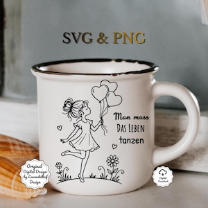 May include: White ceramic mug with a black rim, featuring a black and white illustration of a girl holding heart-shaped balloons. The text "Man muss das Leben tanzen" is also on the mug. The mug has a handle and is on a light surface.