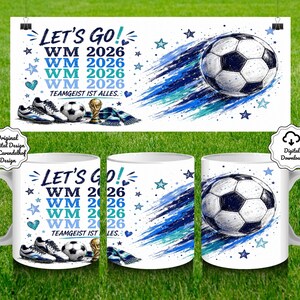 May include: White ceramic mugs with a soccer theme. The mugs feature a soccer ball graphic with blue and black accents, along with the text "LET'S GO! WM 2026" and other soccer-related imagery. The design is repeated on a banner.