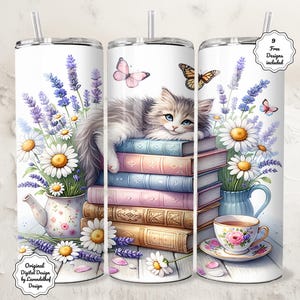 May include: A white tumbler featuring a watercolor design of a fluffy gray cat resting on a stack of books. The design includes lavender, daisies, butterflies, and a teacup. The tumbler has a silver lid and a straw. Text on the tumbler reads "Original Digital Design by Lavendelhof Design."