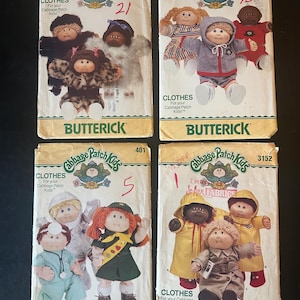 May include: Four vintage Butterick sewing pattern envelopes for Cabbage Patch Kids clothing. The envelopes feature illustrations of the dolls in various outfits, including coats, dresses, and pajamas. The patterns are numbered and include the Cabbage Patch Kids logo.