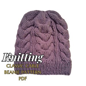 May include: A knitted lavender beanie with a classic cable design. The hat features a textured pattern and is made of soft yarn. Text on the image reads "Knitting CLASSIC CABLE BEANIE PATTERN PDF".