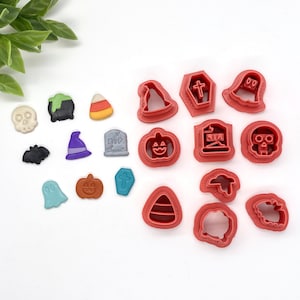 May include: A set of 16 red plastic Halloween cookie cutters. The cutters are shaped like a ghost, a witch's hat, a pumpkin, a skull, a bat, a cauldron, a candy corn, a tombstone, a cross, a hat, a house, a candy cane, a ghost, a pumpkin, a spider, and a spider web.