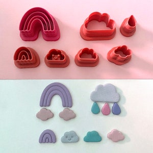 May include: A set of pink plastic cookie cutters shaped like rainbows and clouds, and a set of purple, blue, and pink fondant cutouts shaped like rainbows and clouds.