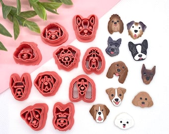May include: A set of 18 pink plastic dog-shaped cookie cutters. The cutters are arranged in a semi-circle on a pink and white background.
