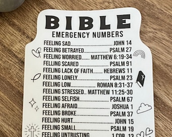 May include: White sticker with black text and illustrations. The sticker says "BIBLE EMERGENCY NUMBERS" and lists different feelings and corresponding Bible verses. For example, "Feeling Sad... John 14".