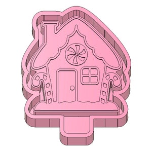 May include: Pink plastic gingerbread house cookie cutter. The cutter features a candy cane design on the sides, a candy swirl on the front, and a window and door.