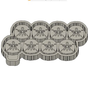 Puede incluir: Un molde de silicona gris en forma de nube con ocho impresiones circulares para hacer galletas con forma de dólar de arena u otras golosinas.