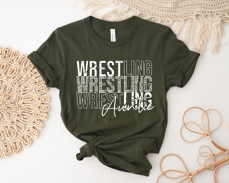 May include: A green t-shirt with the text "Wrestling Auntie" in white with a distressed look.