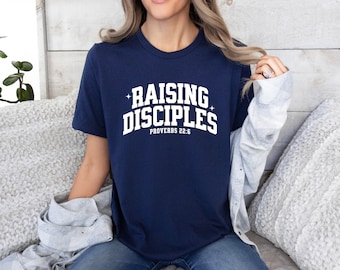 May include: A navy blue t-shirt with white text that reads "Raising Disciples" and "Proverbs 22:6".