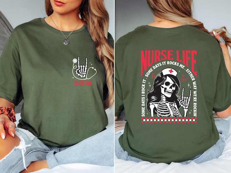 May include: Olive green t-shirt with a skeleton hand and stethoscope graphic. The front of the shirt has the word "NURSE" in red. The back of the shirt has the words "NURSE LIFE" and a skeleton nurse graphic.