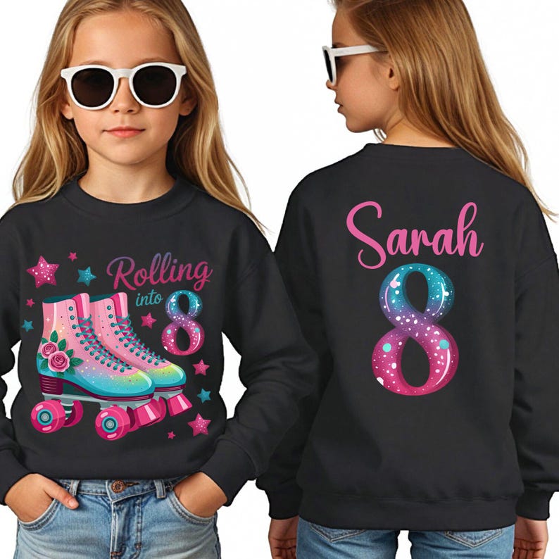 May include: Black sweatshirt featuring a roller skate design with the text "Rolling into 8". The back displays the name "Sarah" and a large number "8", in blue and pink. A fun, colourful design.