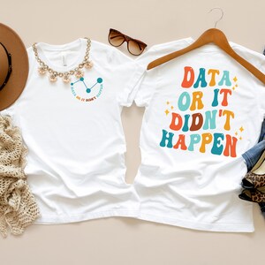 May include: Two white t-shirts with different designs. The left shirt has a blue and orange graphic with the text "Data or it didn't happen". The right shirt has the text "Data or it didn't happen" in colorful retro font.