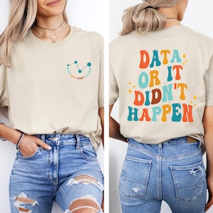 May include: A beige t-shirt with a graphic on the front that says "Data or it didn't happen" and a graphic on the back that says "Data or it didn't happen" in colorful retro lettering.