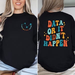 May include: Black sweatshirt with a graphic on the front that says "Data or it didn't happen" with a line graph design. The back of the sweatshirt has the same text in a retro font with colorful letters.