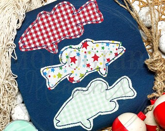 May include: Three embroidered fish appliques on a dark blue fabric. The fish are in different patterns: red and white gingham, colourful stars, and green and white gingham.