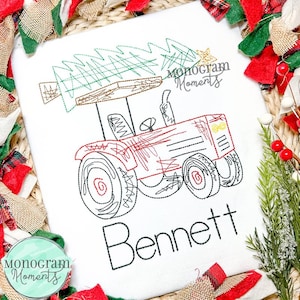 May include: A red tractor with a Christmas tree on top, the text "Monogram Moments" is in the top right corner, and the name "Bennett" is written below the tractor.
