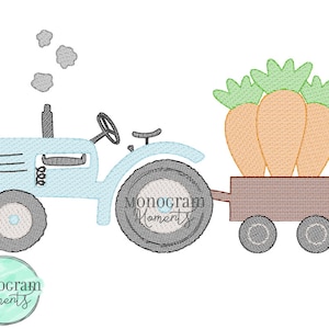 May include: A light blue tractor with a black steering wheel and wheels, pulling a brown wagon filled with three large orange carrots with green tops. The image includes the text "Monogram Moments".