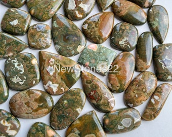 May include: A collection of 20 green, brown, and white ocean jasper cabochons. The cabochons are polished and have a variety of shapes and sizes.