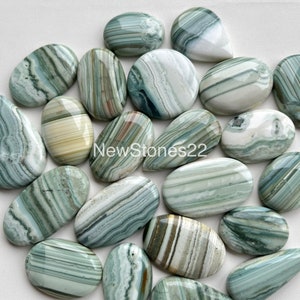 May include: A collection of 17 polished green, white, and brown banded agate cabochons. The cabochons are oval and teardrop shaped. NewStones22 is printed on the image.