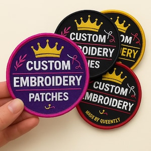 May include: A selection of custom embroidery patches. The circular patches feature a crown design and the words "CUSTOM EMBROIDERY PATCHES". The patches are in purple, black, and red with pink and yellow detailing.