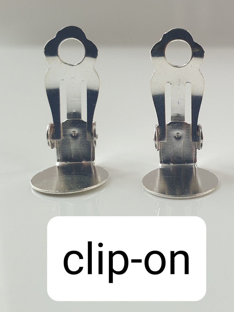 clip on earring back part which is flat back, metallic, silver color, anti allergic, nickel free and little adjustable to make them even more comfortable.